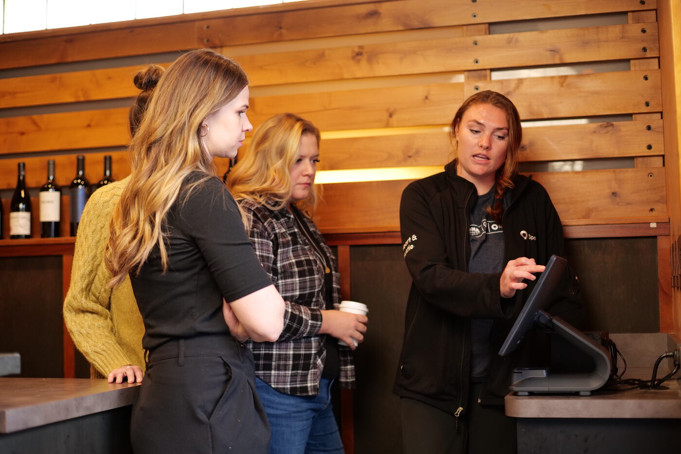 A trainer walking restaurant staff through the counter terminal